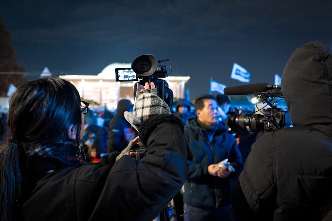 Broadcast camera filming a live outdoor news report